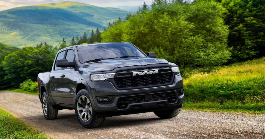 Gray Ram 1500 Ramcharger Big Horn driving up a country road.