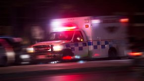 An ambulance driving at speed on city streets.