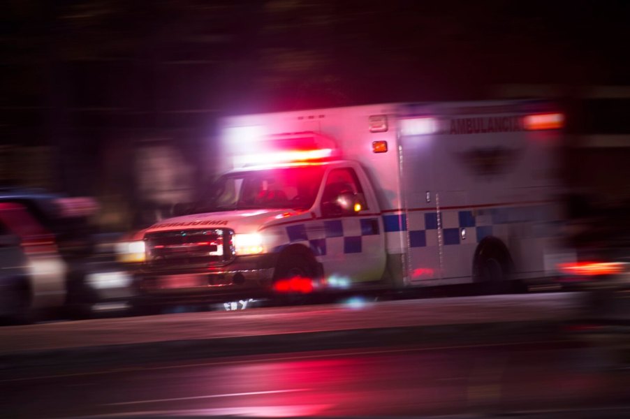 An ambulance driving at speed on city streets.