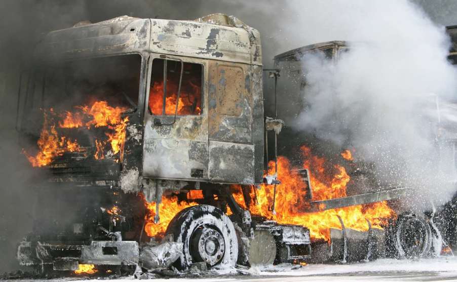 Semi truck burning on the highway