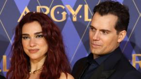 Dua Lipa and Henry Cavill take pictures at the premier of Argylle.