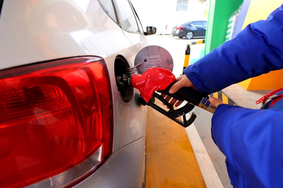 A person putting gas in their vehicle