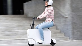 A girl riding the Honda Motocompacto in the city