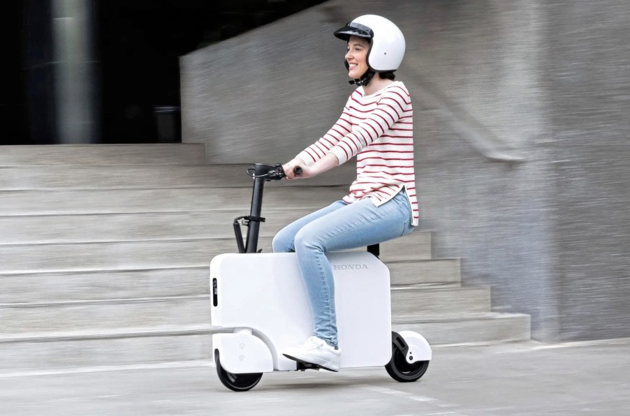 A girl riding the Honda Motocompacto in the city