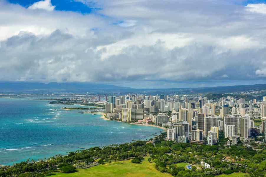 The skyline of Honolulu Hawaii, the Pacific Ocean visible in the background.