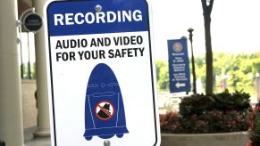 Sign warning the public a police sentry patrol robot is recording video.