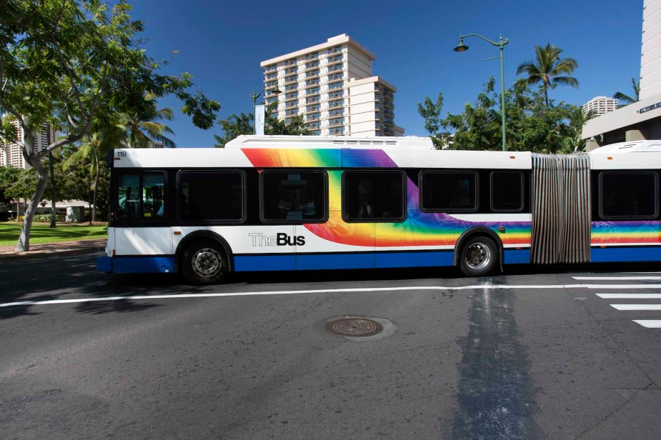 Two-section bus drives through the airport in Honolulu Hawaii