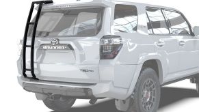 A white Toyota 4Runner TRD Pro SUV with an aftermarket ladder by Front Runner installed