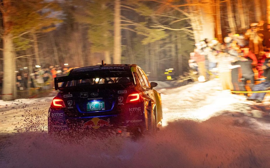 Travis Pastrana's Subaru skids through Sno*Drift Rally's bonfire alley