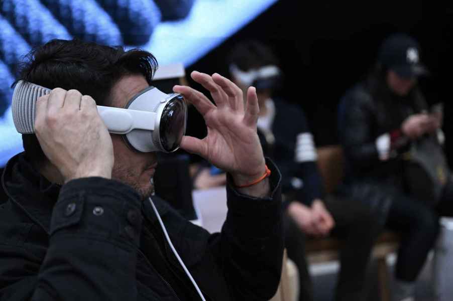 A man tries on an Apple Vision Pro in an Apple store