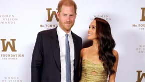 Meghan Markle and Prince Harry photographed attending an NYC event on May 16, 2023 a paparazzi police chase would follow Meghan wearing gold dress Harry in a suit with blue tie