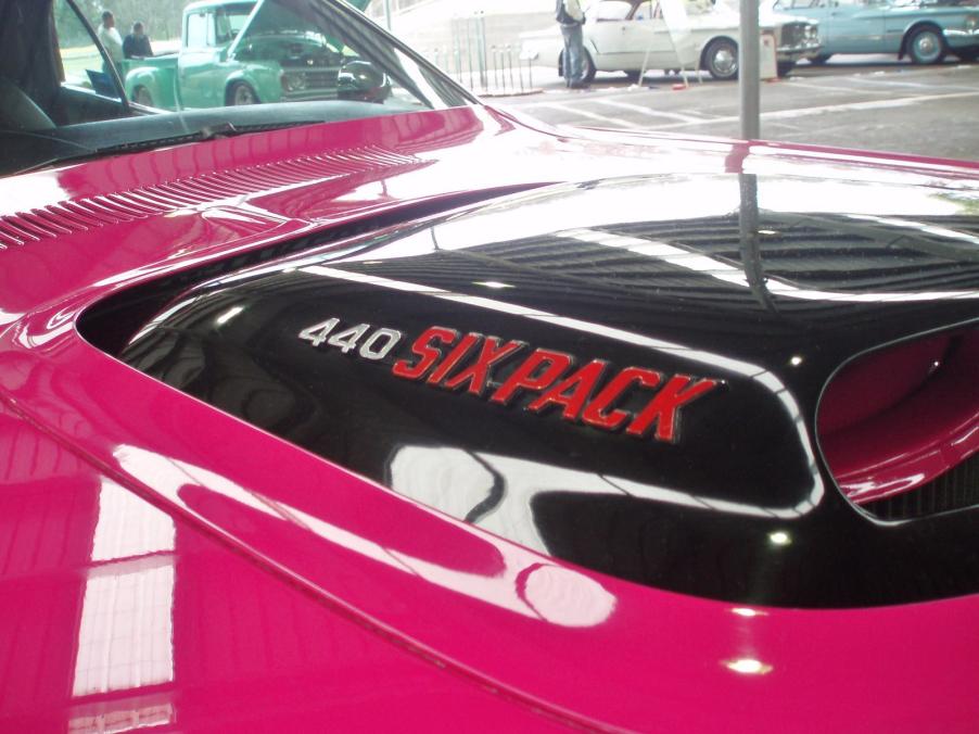 bright pink Dodge Challenger muscle car's black hood scoop with 440 Six Pack on the side