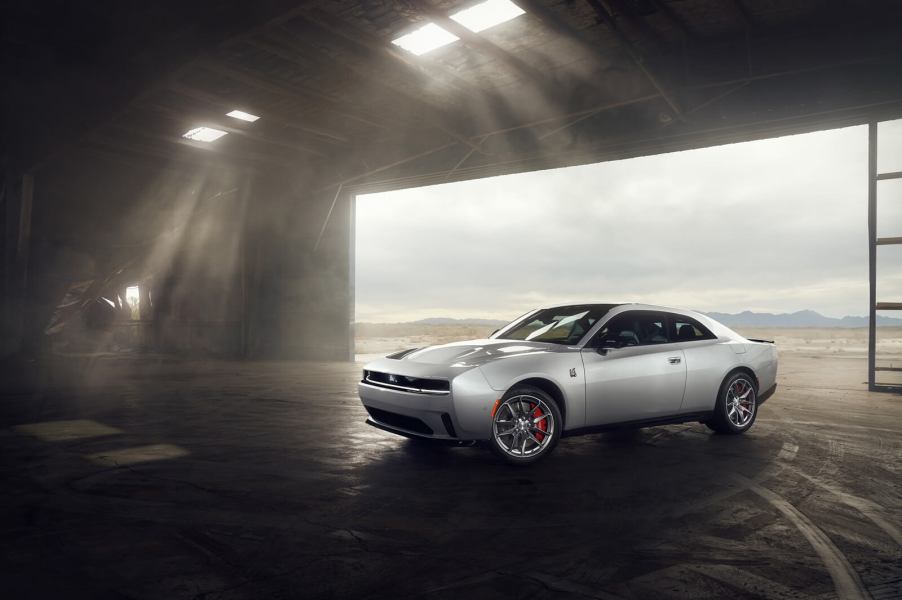 A new 2024 or 2025 Dodge Charger sits in a hangar.