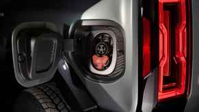 A GMC Hummer EV SUV charge port shown in close view