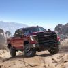 The 2024 GMC Sierra 2500 HD AT4X crawling over rocks