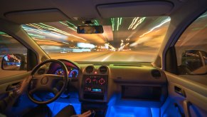 Sedan with a glowing blue light beneath its dashboard