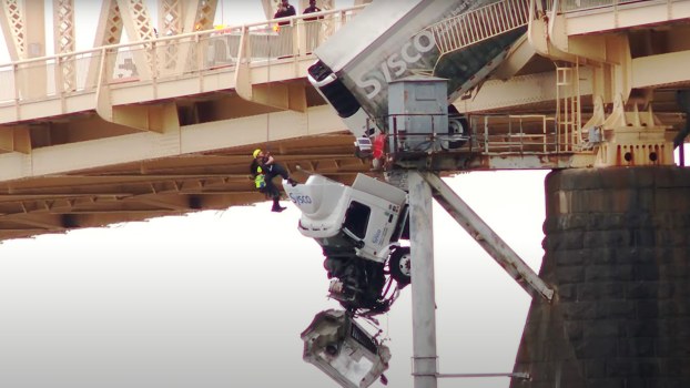 Firefighter Jumps off Bridge, Prays with Trapped Semi-Truck Driver Waiting for Rescue