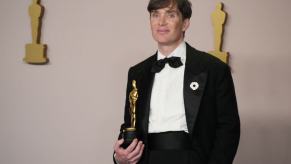 Cillian Murphy, an Oscar winner, shows off his Oscar before leaving in a car.