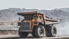 Heavy-duty yellow dump truck parked in the middle of a mine.