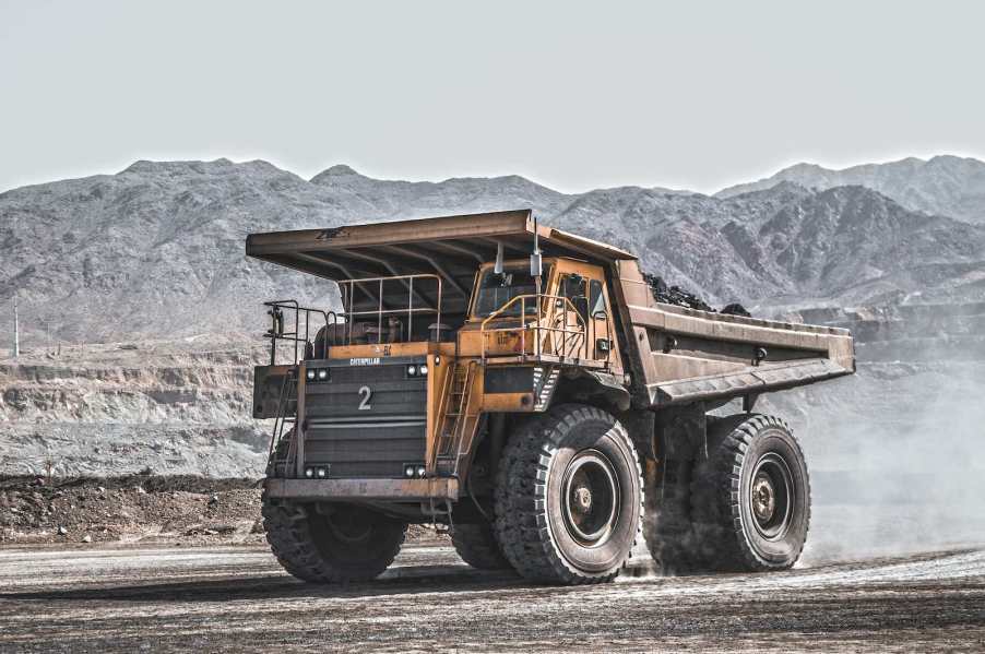 Heavy-duty yellow dump truck parked in the middle of a mine.