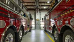 A set of fire trucks in the station.