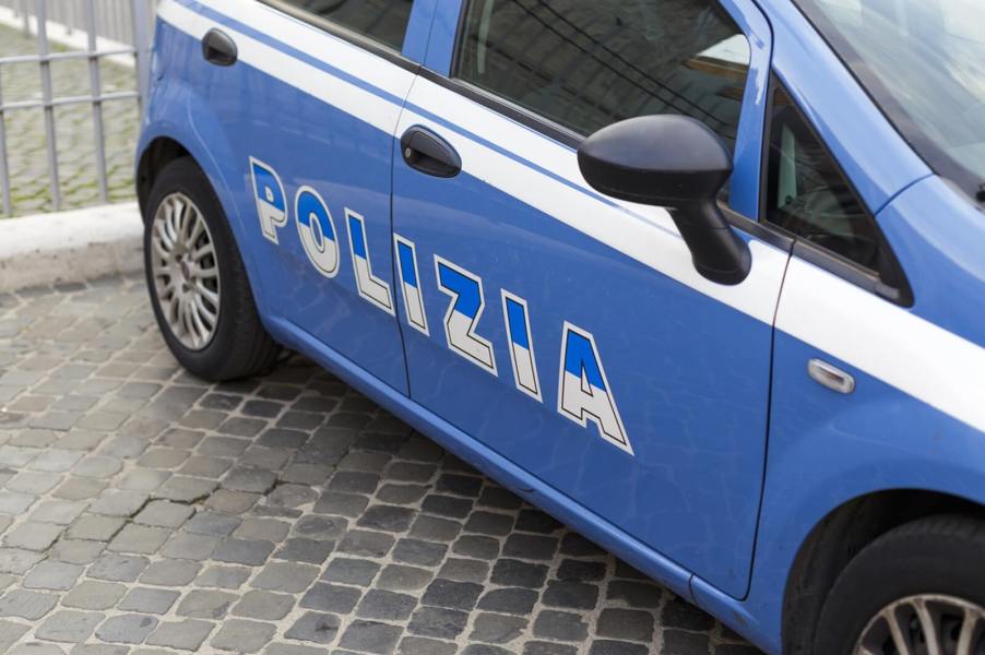 The side of an Italian police car marked with the word 'Polizia'.