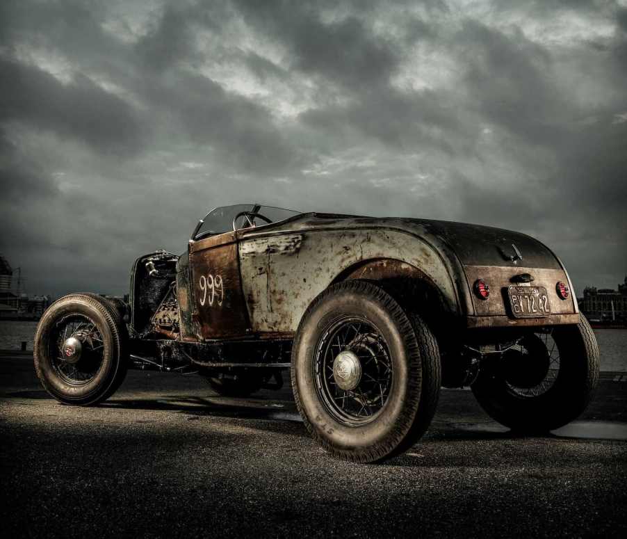 Ratty hot rod car in front of a gray sky