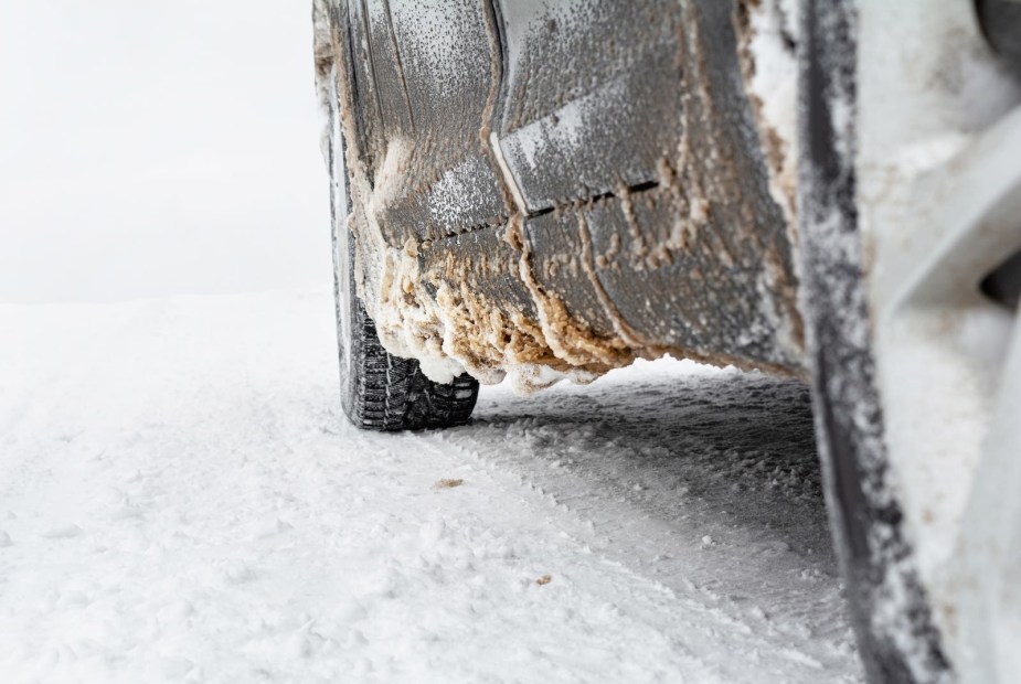 Road salt and snow gathered on the bottom of a car