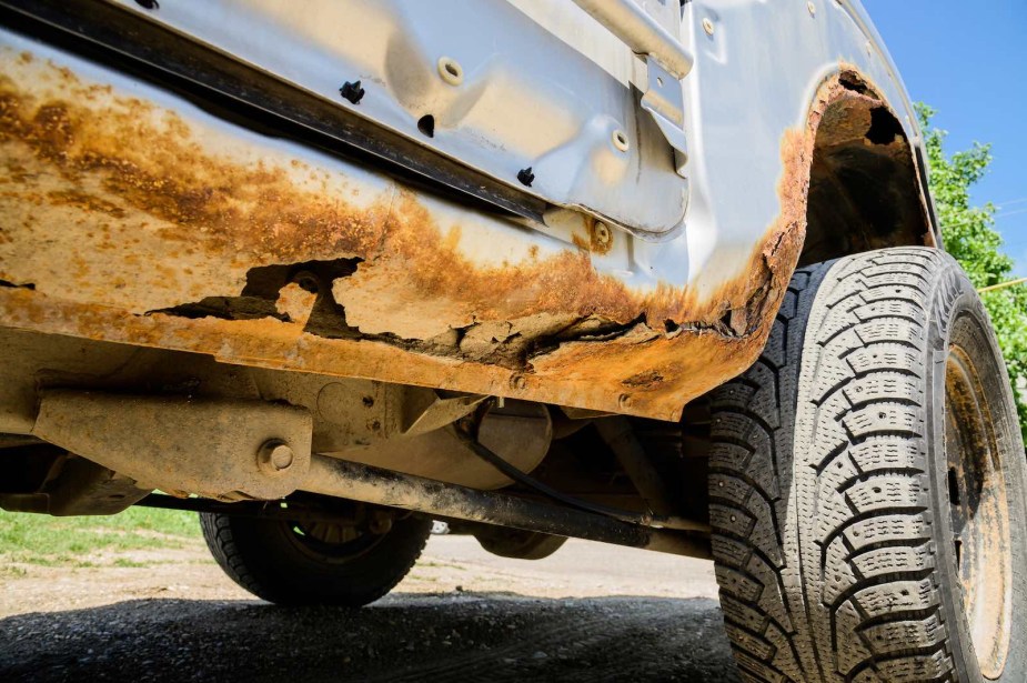 The underside of a car with rust holes