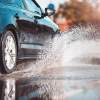 A Volkswagen sedan displaces water to avoid hydroplaning or aquaplaning.