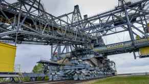 The F60 overburden conveyor bridge world's largest land vehicle is shown on a set of rail tracks in close left front view