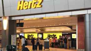 A Hertz rental car storefront in an airport