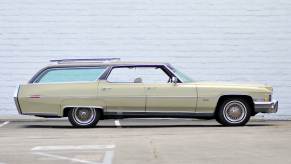 Custom Cadillac station wagon sitting in front of a white wall.