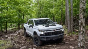 The 2024 Chevy Silverado 1500 off-roading in the woods