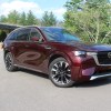 The 2024 Mazda CX-90 parked near foliage