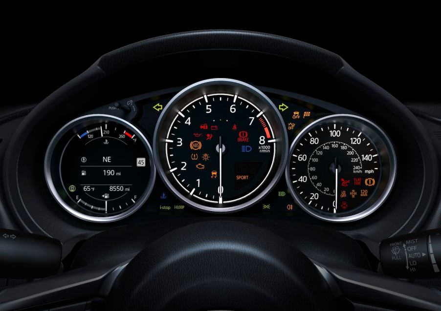 The tachometer and other gauges on a Mazda Miata's dashboard.