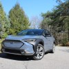 The 2024 Subaru Solterra parked near foliage