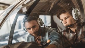 A helicopter instructor and student train together in the helicopter license process.