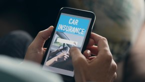 Man searches for auto insurance providers on a broker website on his phone