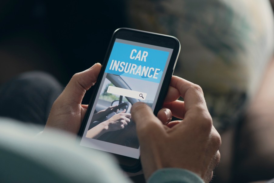 Man searches for auto insurance providers on a broker website on his phone