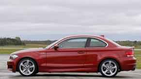 An E82 BMW 1 Series, like the 128i or 135i, shows off its side profile.