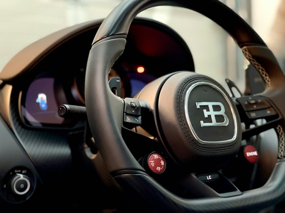 The steering wheel and dashboard of a Bugatti Chiron supercar.