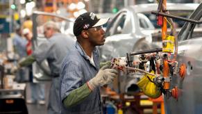 A Detroit factory worker assembling a Chevrolet Malibu