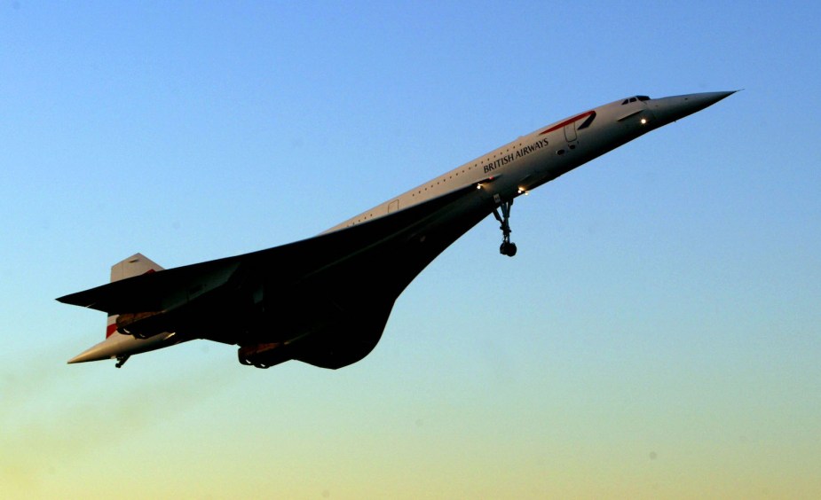 Concorde jet flying in front of the sunset.