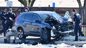 Police surround SUV involved in a front collision.