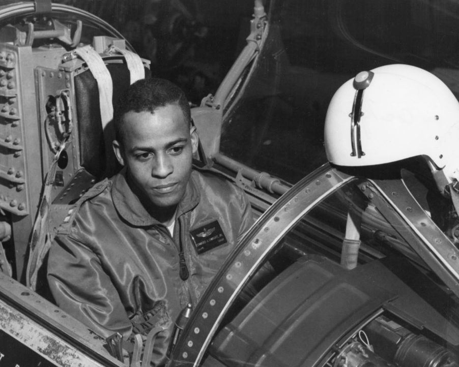 Black and white photo of test pilot Ed Dwight sitting in the cockpit of a plane