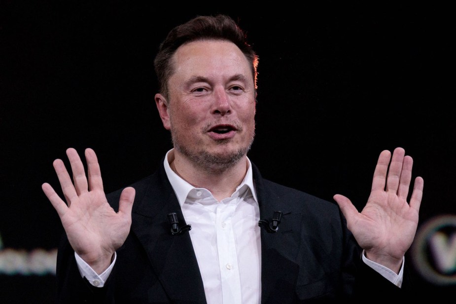 Tesla's CEO, Elon Musk, wears a suit during a press conference.