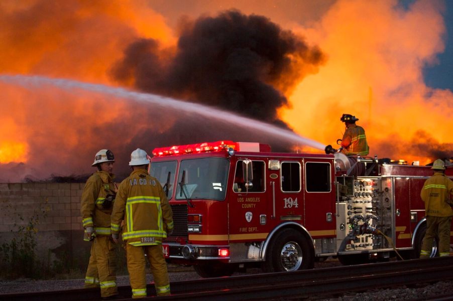 A crew uses a fire truck and its water capacity to fight a blaze.