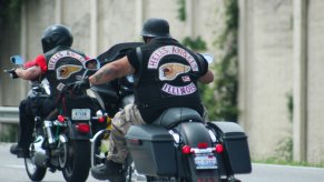 Two motorcyclists with Hell's Angels club patches ride on the interstate.