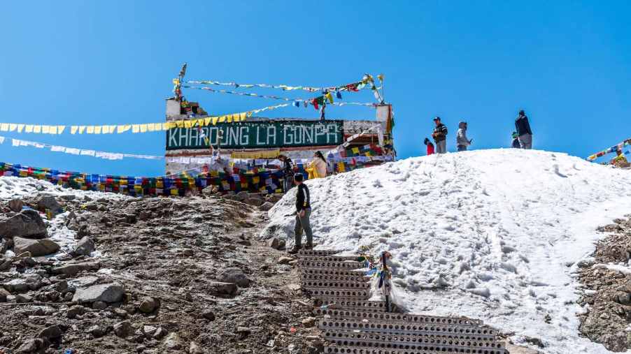 Travelers climb to a hillside temple.